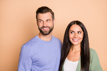 Obraz premium Photo of young happy smiling cheerful lovely couple husband and wife look copyspace isolated on beige color background