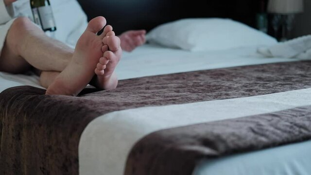 male legs lie on the bed