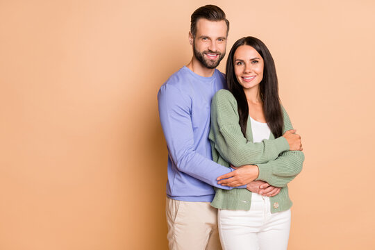 Photo Of Young Happy Cheerful Positive Good Mood Couple Wife And Husband Cuddle Isolated On Beige Color Background