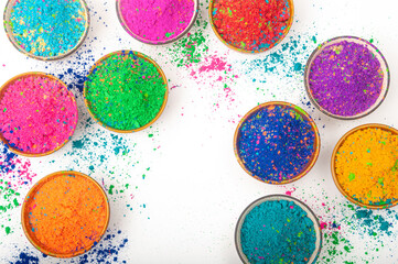 Happy Holi top view of colorful holi colors in bowls with Splash, Concept Indian color festival. 