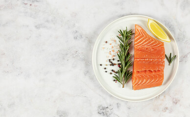 Fresh raw Atlantic salmon on the plate. Great source of omega-3 fatty acids, protein, potassium, and selenium.