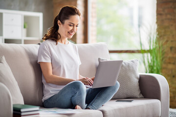 Full length portrait of cheerful charming person sit hold netbook browsing have good mood working...