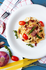 Spicy spaghetti bacon sauce with ingredient homemade on the wooden table.