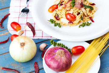 Spicy spaghetti bacon sauce with ingredient homemade on the wooden table.