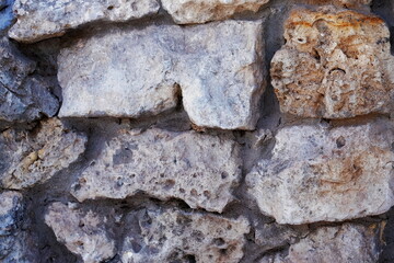 A fragment of an old ruined wall. Retro. Masonry. Tinted frame. Horizontally. Grunge.
