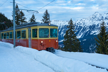 A train of the historic railway arrives at Muerren, a village in Switzerland