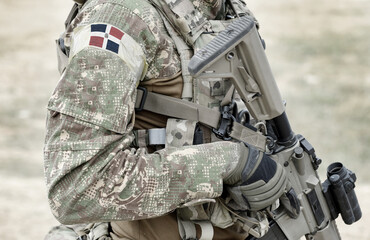Soldier with assault rifle and flag of Dominican Republic on military uniform. Collage.