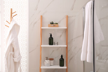 Plants and different toiletries on decorative ladder in bathroom. Interior design © New Africa