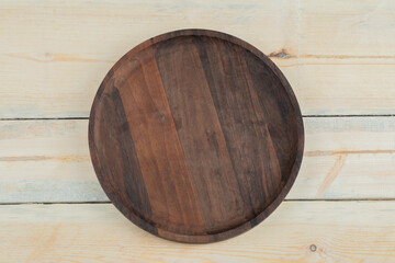 Round wooden platter carved from oak tree