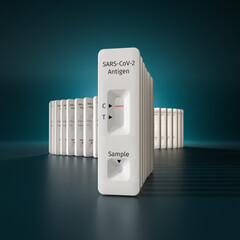 Mass testing for Covid-19 / SARS-CoV-2 infection concept: Several rapid antigen test kits on a...