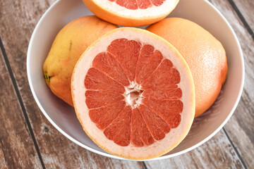 Obraz na płótnie Canvas Grapefruits in bowl. Juicy fruit