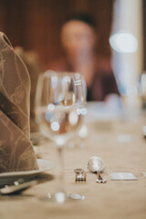 people eating in a restaurant.wine glass close up on table background