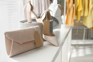Fototapeta na wymiar Women's bag and high heel shoes in modern clothing boutique