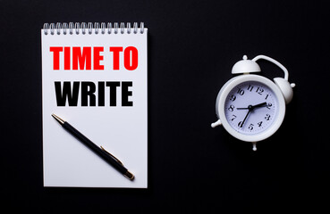 TIME TO WRITE is written in a white notepad near a white alarm clock on a black background.