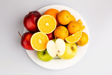 Mix fruit with white dish in isolated background on top angle.