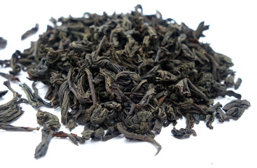 Dry black tea isolated on white with blur effect.