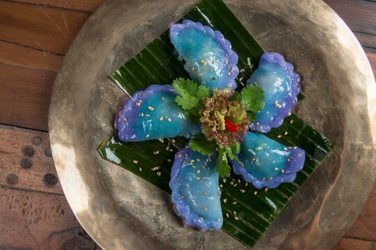 Kanom Gib Thai, rice dumpling with steamed mauve tea leaves. blue dumpling
