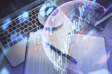 Stock market graph and top view computer on the table background. Multi exposure. Concept of financial education.