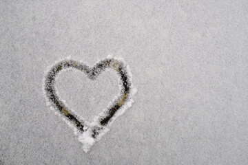 heart shape drawn in the snow surface close-up. Top view. Copy space. Love concept. St. Valentine's Day