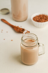 Non dairy buckwheat milk in glass jar, closeup view