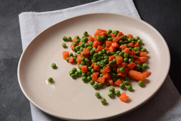 Boiled carrots and peas. Healthy food