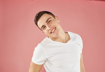 Cute man and white t-shirt hand gesture emotions pink background