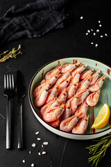 shrimp in a plate on black textured background
