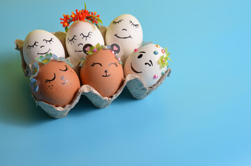 Easter eggs with funny faces on a blue background. Spring. Easter.