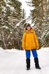 Fototapeta na wymiar happy woman in warm clothes in winter forest