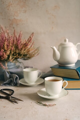 Obraz na płótnie Canvas Still life tea time with books and flowers
