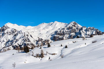 Closeup of the snowcapped mountains in winter of the Monte Carega, called the small Dolomites from the Altopiano della Lessinia (Lessinia High Plateau). Veneto and Trentino Alto Adige, Italy, Europe.