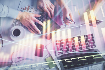 Double exposure of man and woman working together and financial chart hologram drawing. market analysis concept. Computer background. Top View.