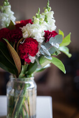 Close up of bouquet of flowers to a loved one in a glass vase