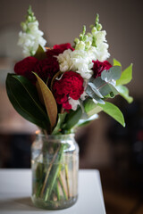 Close up of bouquet of flowers to a loved one in a glass vase