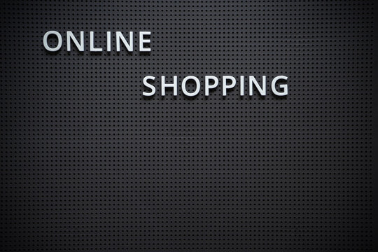 Online shopping text on a dark grey board Conceptual photography Shopping from home concept
