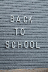Fototapeta premium Back to school phrase embedded on grey background