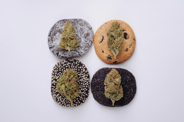 Cookies and marijuana buds closeup. Cannabis flowers on white background, canna kitchen. Hemp recreation, pastime, legalization concept.