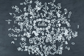 White plastic letters, icons and symbols on grey background