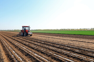 Farmers drive seeders to grow Plastic Mulched peanuts on the farm.