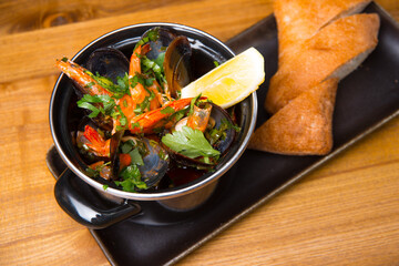 Photo of tasty delicious fresh mussels boiled in a pan, sea food.