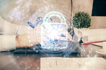 Multi exposure of man's hands holding and using a digital device and lock drawing. Security concept.