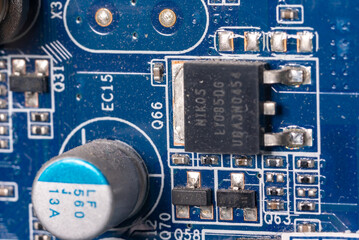 macro shot of a microcircuit and a transistor on the motherboard of a personal computer