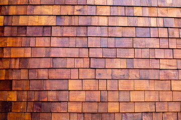 The background of small teak panels connected together as a wall. Wooden background.