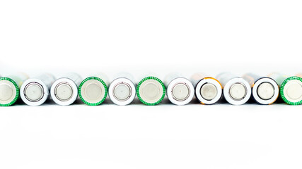 Used alkaline batteries lying in a row isolated on a white background