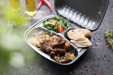 Takeaway food in a box. Ready prepared meal in a box. Tasty catering delivered to the office.