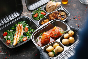 Takeaway food in a box. Ready prepared meal in a box. Tasty catering delivered to the office.