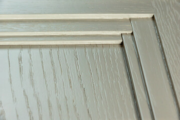 interior corner of a textured white kitchen facade. Paint texture background on wood