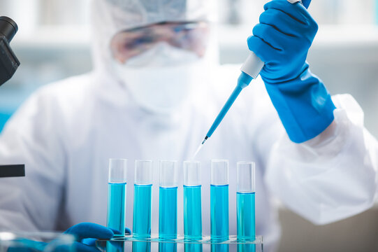 Researchers scientist working analysis with blue liquid test tube in the laboratory, chemistry science or medical biology experiment technology, pharmacy development solution