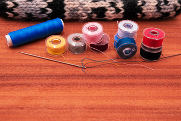 photography of sewing threads of different colors on background