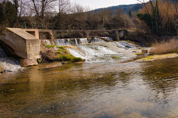 View of the medieval Gothic-style bridge of Santa Maria de Merles, where the river Merles crosses it, a river rich in fluvial fuana. Sta. Maria de Merles, Catalonia, Spain